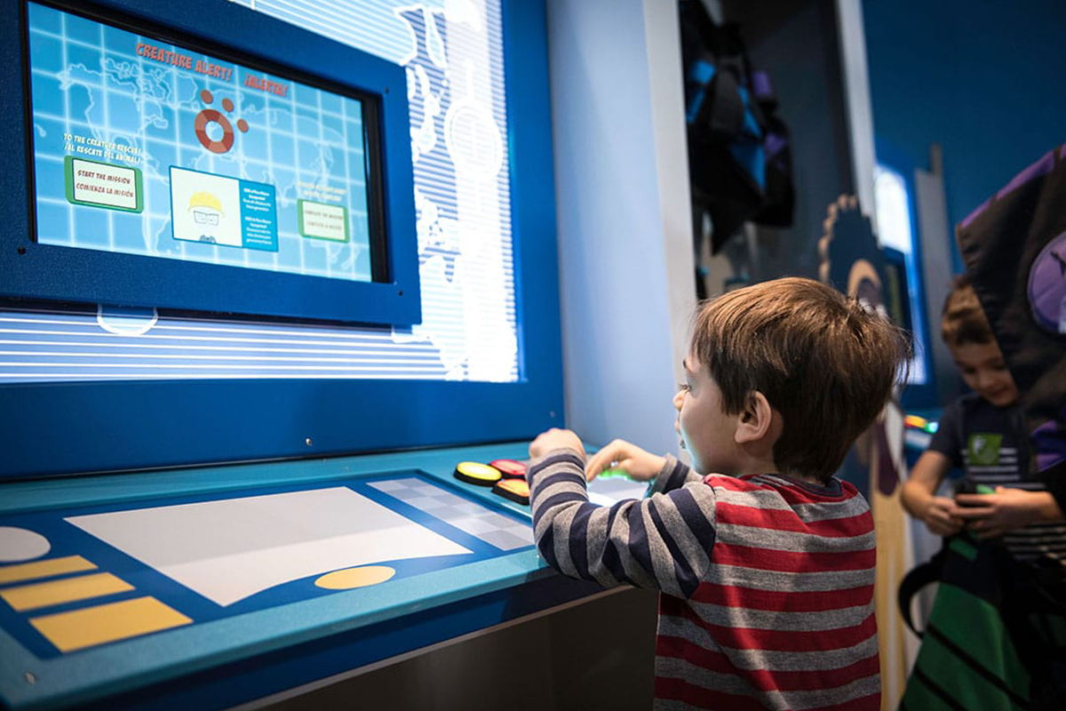 child playing with computer console component